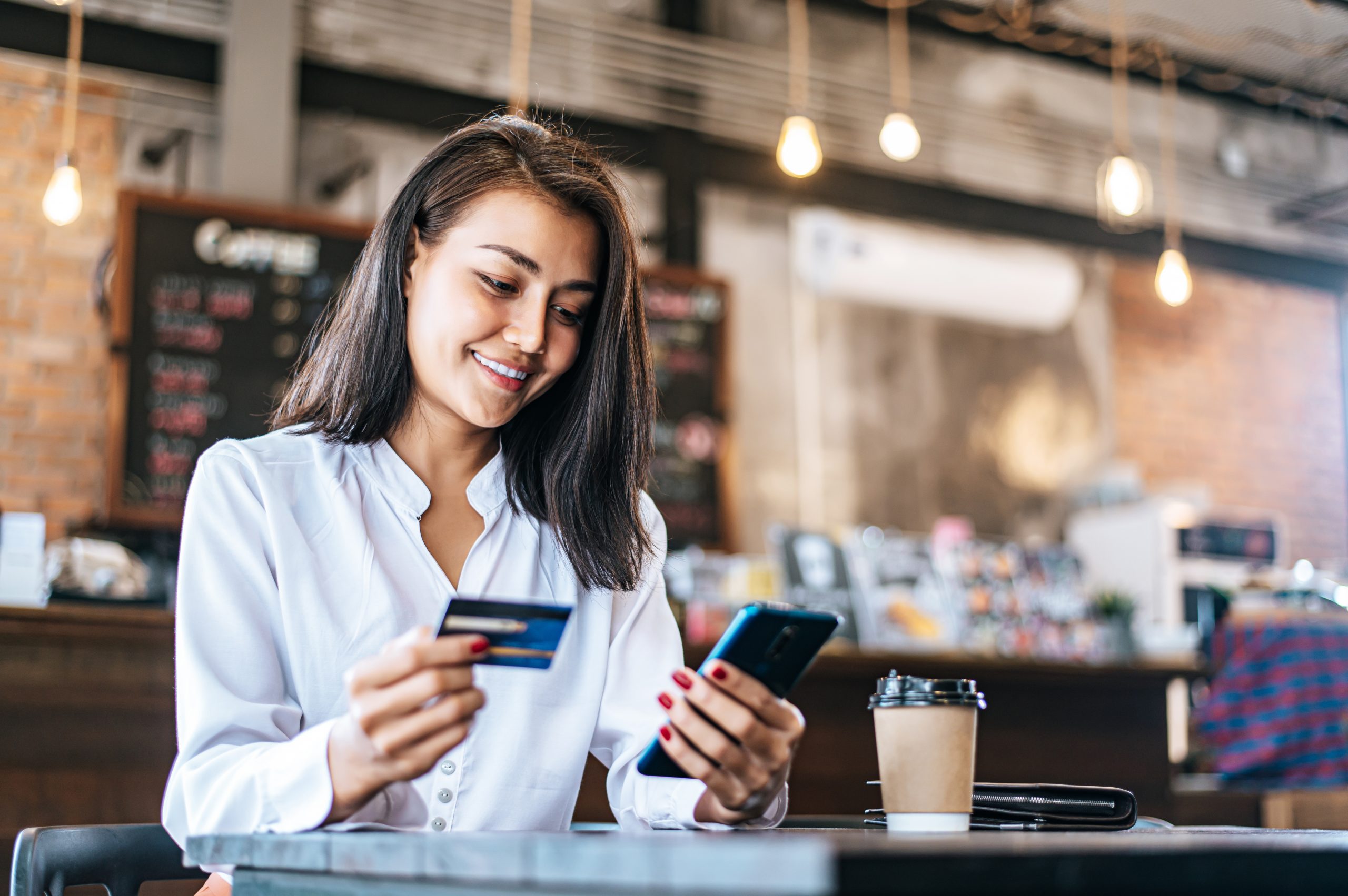 Pay For Goods By Credit Card Through A Smartphone In A Coffee Sh