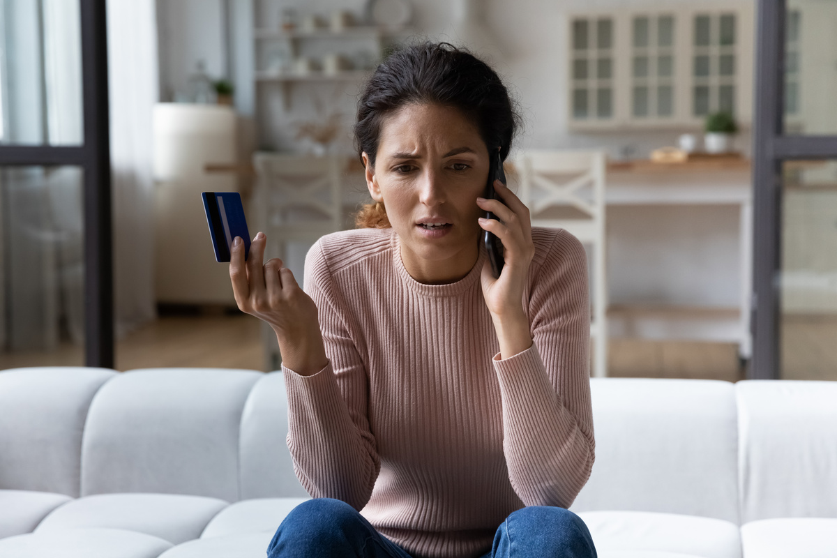 Worried Young Hispanic Woman Call Bank Unable Pay By Card